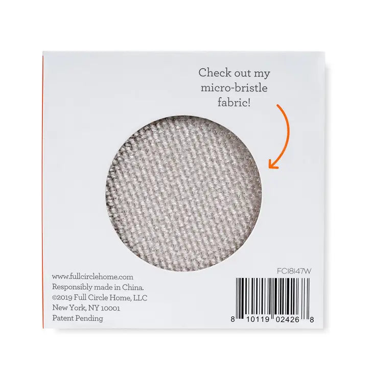 The image features a square package for the Fuzz Off Reusable Lint Remover by Full Circle Home, with a circular cutout displaying microfiber fabric. The text reads, Check out my micro-bristle fabric! Company details and a barcode are included at the bottom.