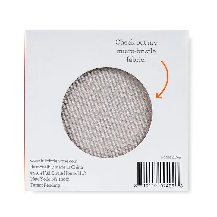 The image features a square package for the Fuzz Off Reusable Lint Remover by Full Circle Home, with a circular cutout displaying microfiber fabric. The text reads, Check out my micro-bristle fabric! Company details and a barcode are included at the bottom.