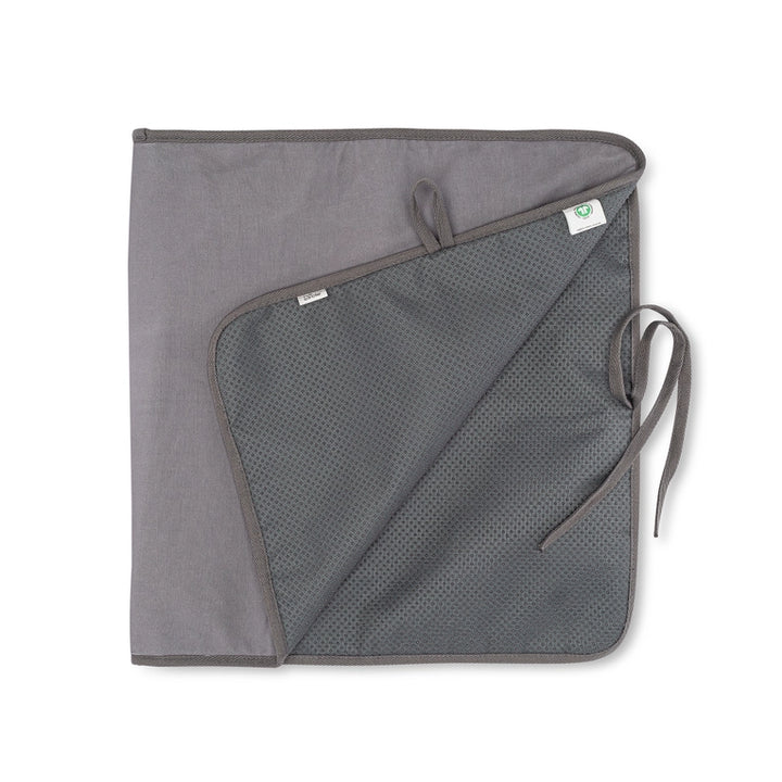 A grey Iron & Steam Blanket by Full Circle Home, resembling a portable ironing board with its dark mesh interior, features a small loop and tie for fastening, while a tag peeks out on one edge.