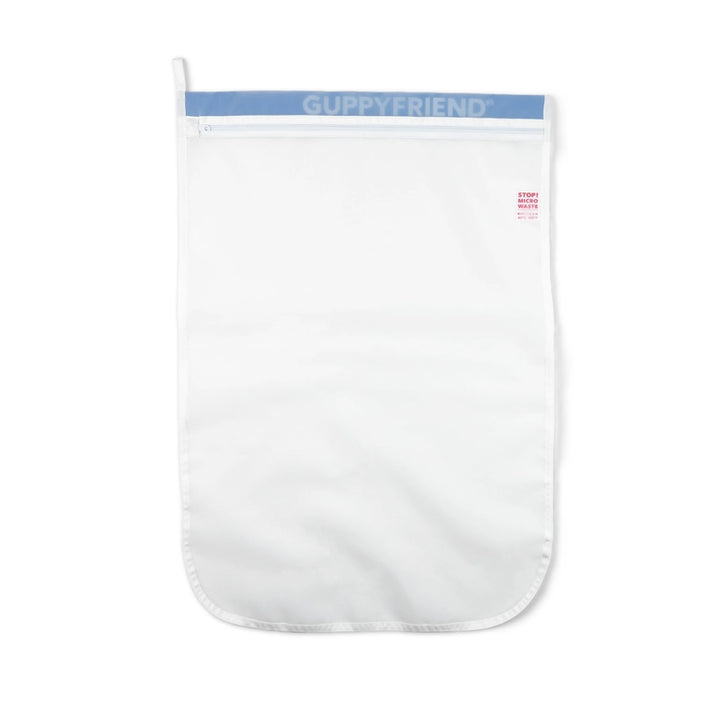 The GUPPYFRIEND Washing Bag-Medium (19.7 in. x 29.1 in.) is a white laundry bag with a blue zipper, designed to minimize fiber shedding and reduce microplastics, featuring a rectangular shape with a rounded bottom edge for efficient cleaning without environmental harm.