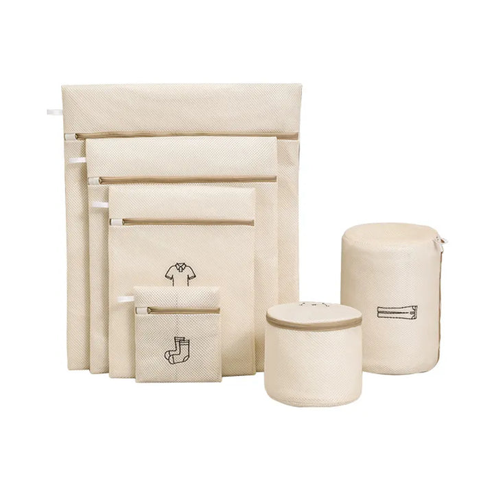 The All Things Laundry Set of 6 Mesh Laundry Wash Bags includes beige bags in various sizes and shapes (rectangular and cylindrical), each with illustrations for use. They protect delicates with zippers for organization, extending clothing life.