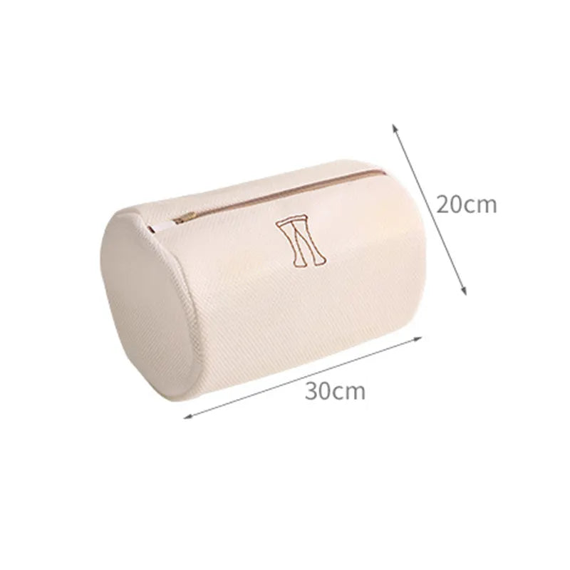 A cylindrical beige pillow with a zipper features a simple illustration of legs and resembles the style and functionality of the Set of 6 Mesh Laundry Wash Bags by All Things Laundry. It measures 30 cm in length and 20 cm in diameter.