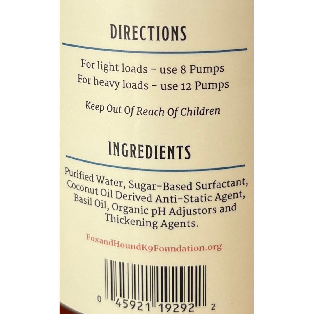 Label for Fox + Hounds 16 oz Natural Pet Laundry Detergent with basil scent: Use 8 pumps for light loads, 12 for heavy. Suitable as an HE detergent. Contains purified water, sugar-based surfactant, coconut oil anti-static agent, basil oil, and organic pH adjustors.