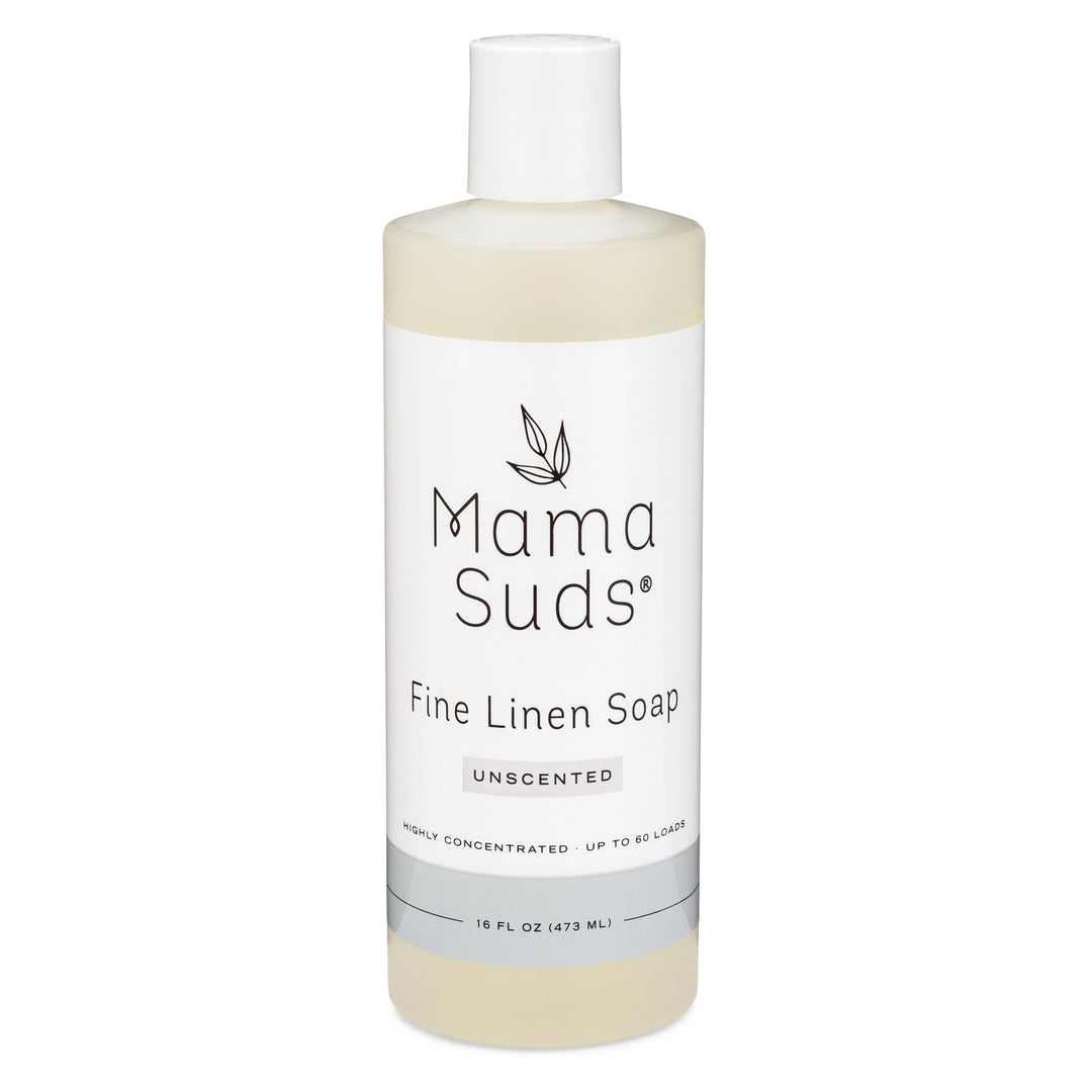 A 16 oz bottle of Mama Suds Fine Linen Soap has a white label with black text and a leaf design. This biodegradable, unscented, non-toxic soap is highly concentrated for up to 60 loads.