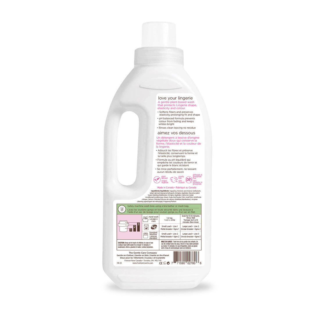 Back view of Fashion Cares Swirl Lingerie Wash - 1L, featuring English and French text on a white and pink eco-friendly label with icons, instructions, and a barcode. Designed for lingerie care with a soft scent, it includes a convenient left-side handle.