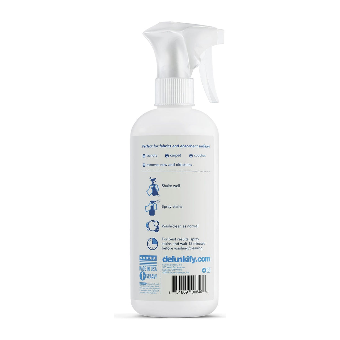 The Stain Remover Spray-Free and Clear by Defunkify is a 16 oz white bottle with icons for laundry, carpets, and couches. Enhanced with enzymes for effective stain removal, it includes the ProvenSafe label. Always shake well before use. Visit defunkify.com printed clearly on the bottle.