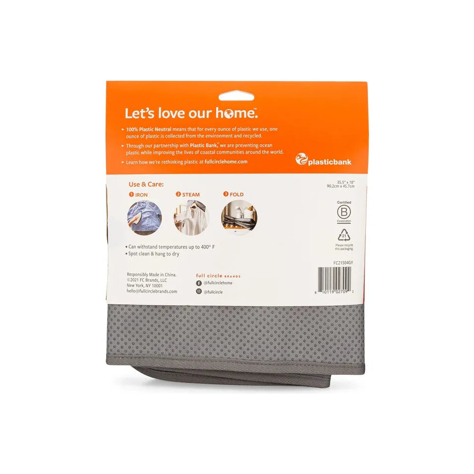 The Iron & Steam Blanket by Full Circle Home features orange and white packaging with text on its plastic-neutral initiative. It includes use and care instructions: iron, steam, fold, temperature guidelines, and sports a stylish dotted pattern.