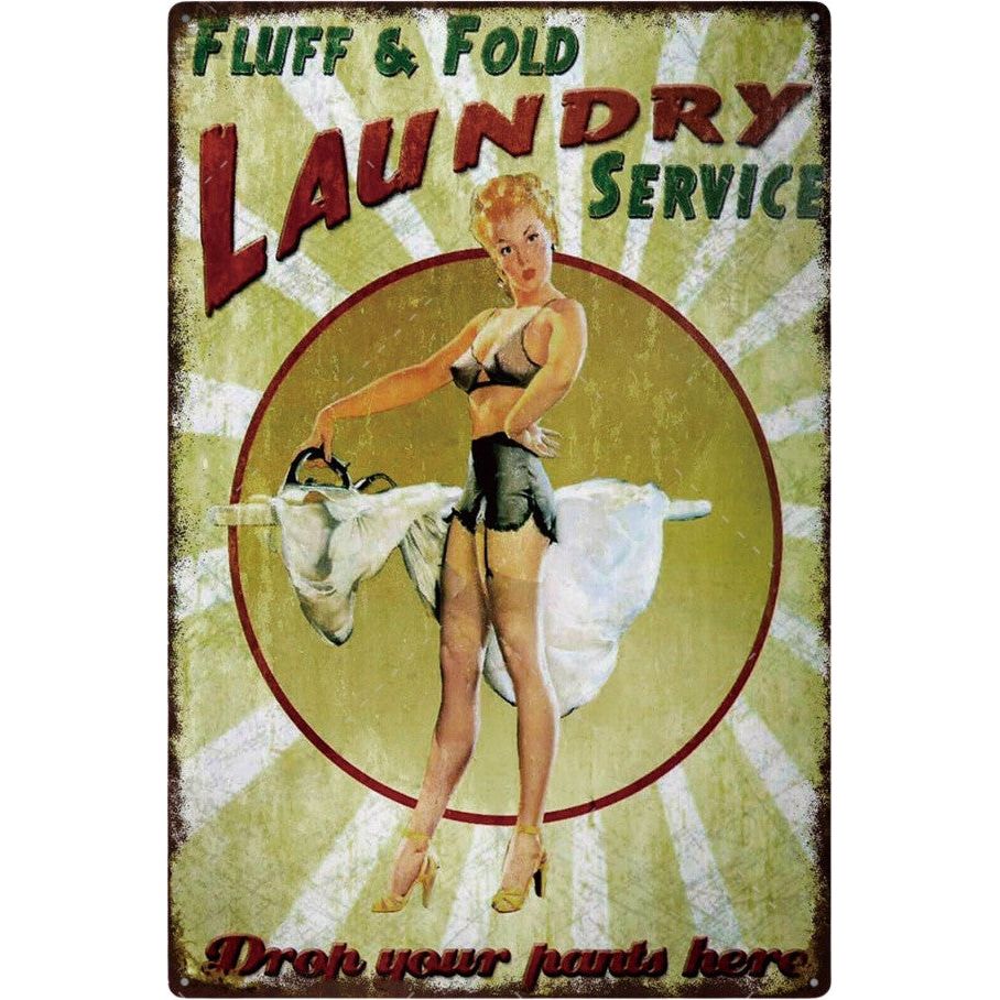 All Things Laundry presents the Fluff and Fold Laundry Service sign, showcasing a vintage-style ad with a woman holding a laundry basket. Above her, Fluff & Fold Laundry Service is boldly displayed, while below reads Drop your pants here, all set against a classic radial burst design.