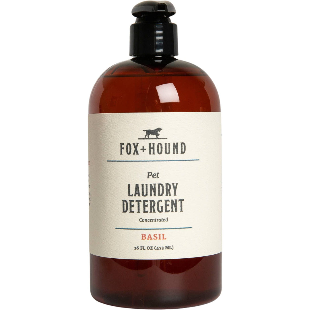 The Fox + Hound Natural Pet Laundry Detergent in basil scent comes in a 16 oz brown bottle with a black pump dispenser, offering a concentrated formula for effective cleaning while being gentle on pet items.