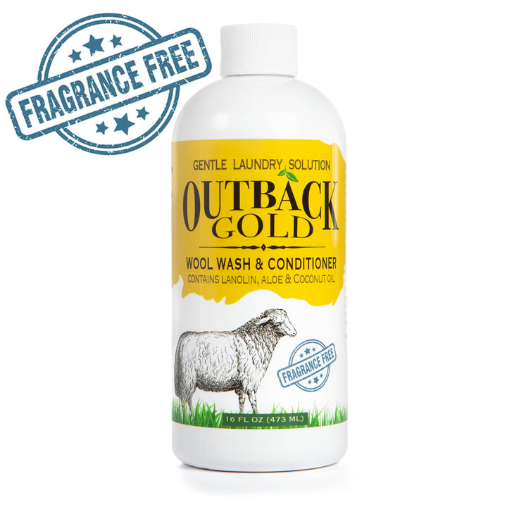 The 16 oz Wool Wash and Conditioner by Outback Gold from Desert Breeze Distributing features a yellow and white label with a sheep illustration. This eco-friendly, fragrance-free detergent is gentle on sensitive skin, enriched with lanolin, aloe, and coconut oil.