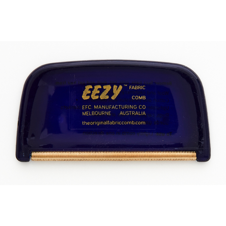 The blue and gold EZY™ Fabric Comb by The Original Fabric Comb features a plastic handle and metal edge for top-notch pilling removal. Crafted in Melbourne, Australia by EFC Manufacturing Co, its your go-to tool for keeping fabrics fresh and smooth.