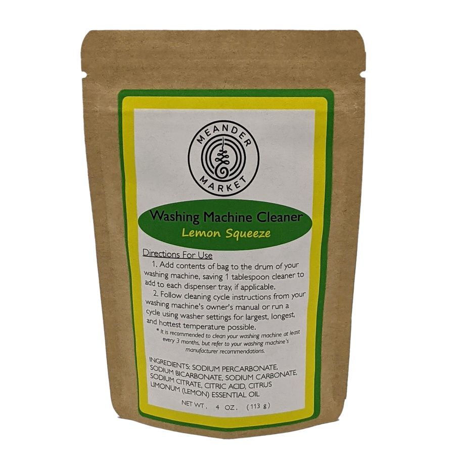 The brown paper bag by Meander Market features a vibrant green and yellow design. Inside, youll find the Washing Machine Cleaner with a Lemon Squeeze scent, handmade in Wisconsin. It includes instructions and ingredients on the front. Net weight: 4 oz (113 g).